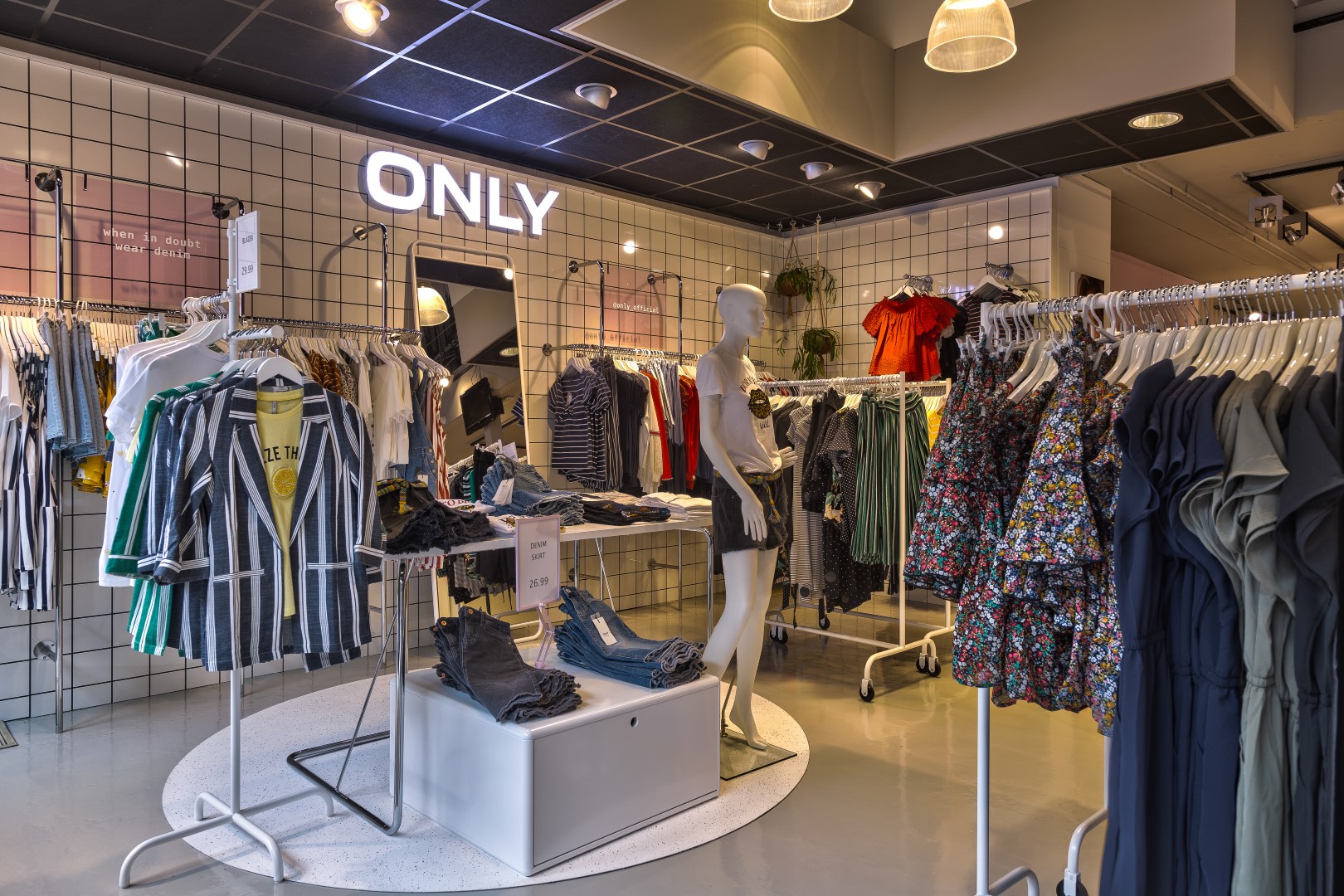 decoration of fashion store with clothing racks and lighting