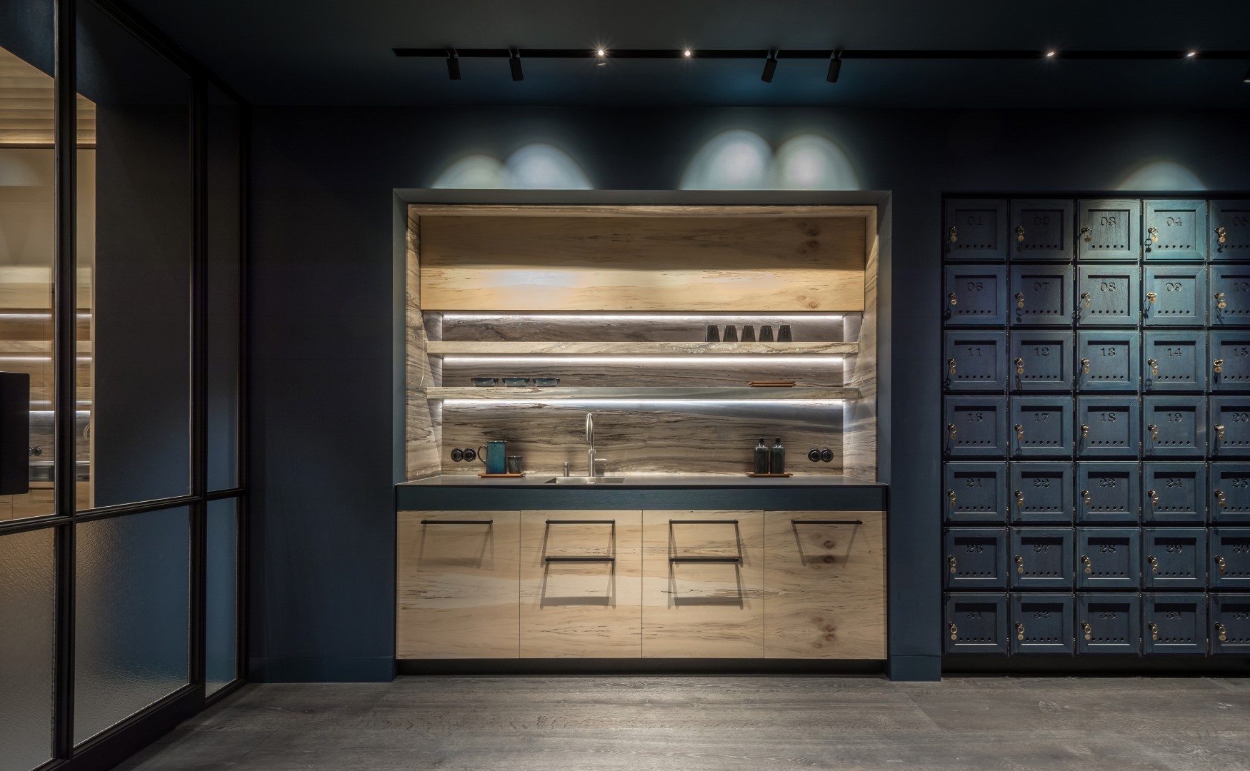 Kitchen design of canteen with blue stained oak lockers.