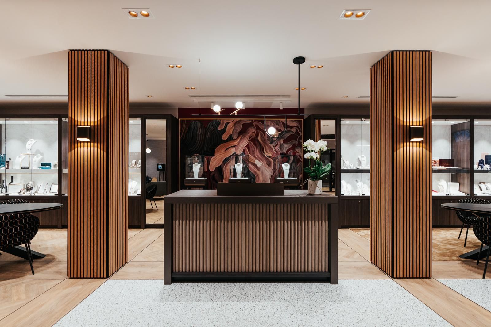 View of the store of jeweler Stievenart Belgium with central sales counter and wall with custom-made display cases