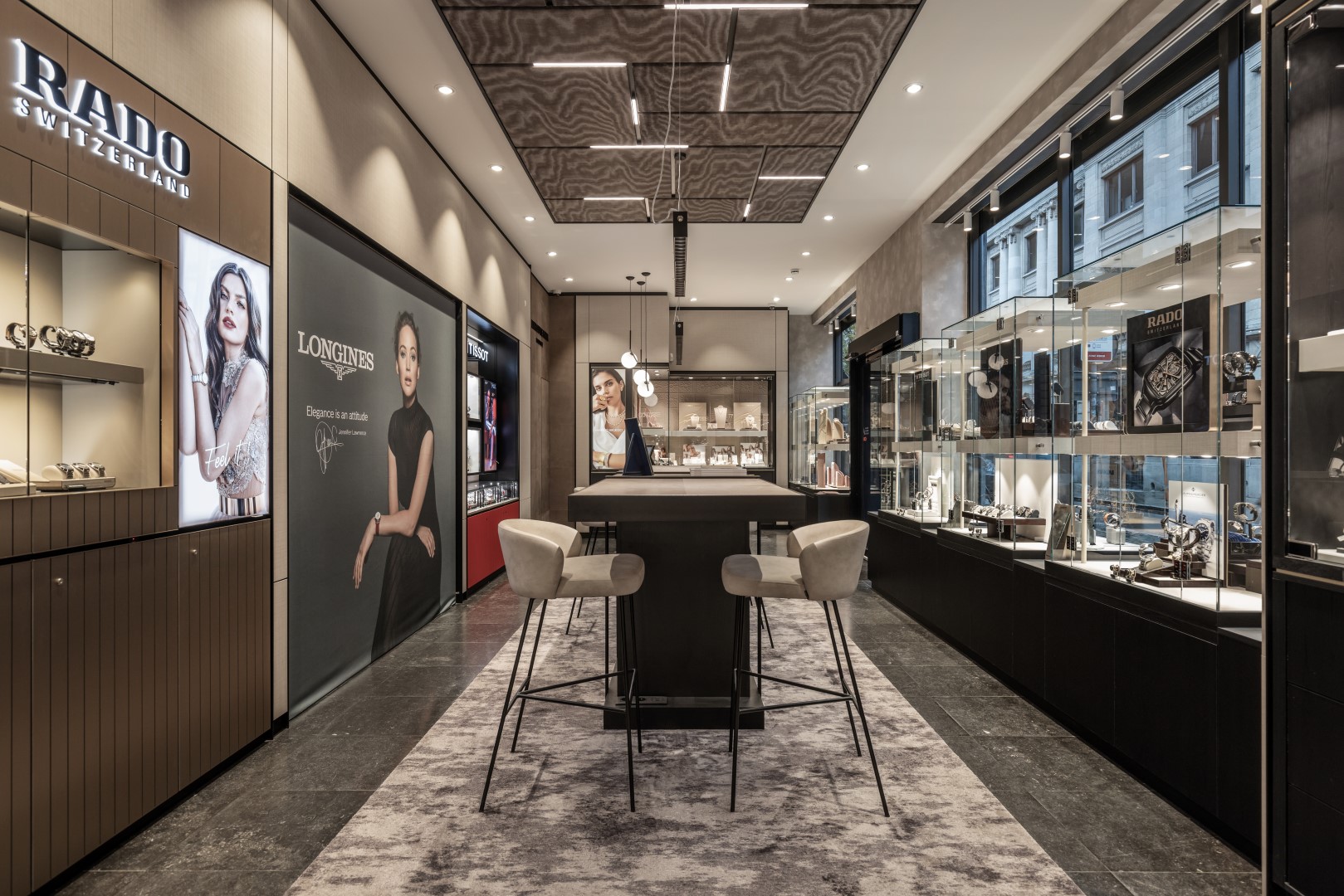 View of the interior with transparent shop window showcases from brands such as Rado and Longines